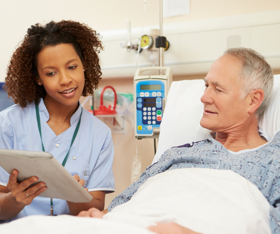 male patient on a hospital bed with a nurse explaining something